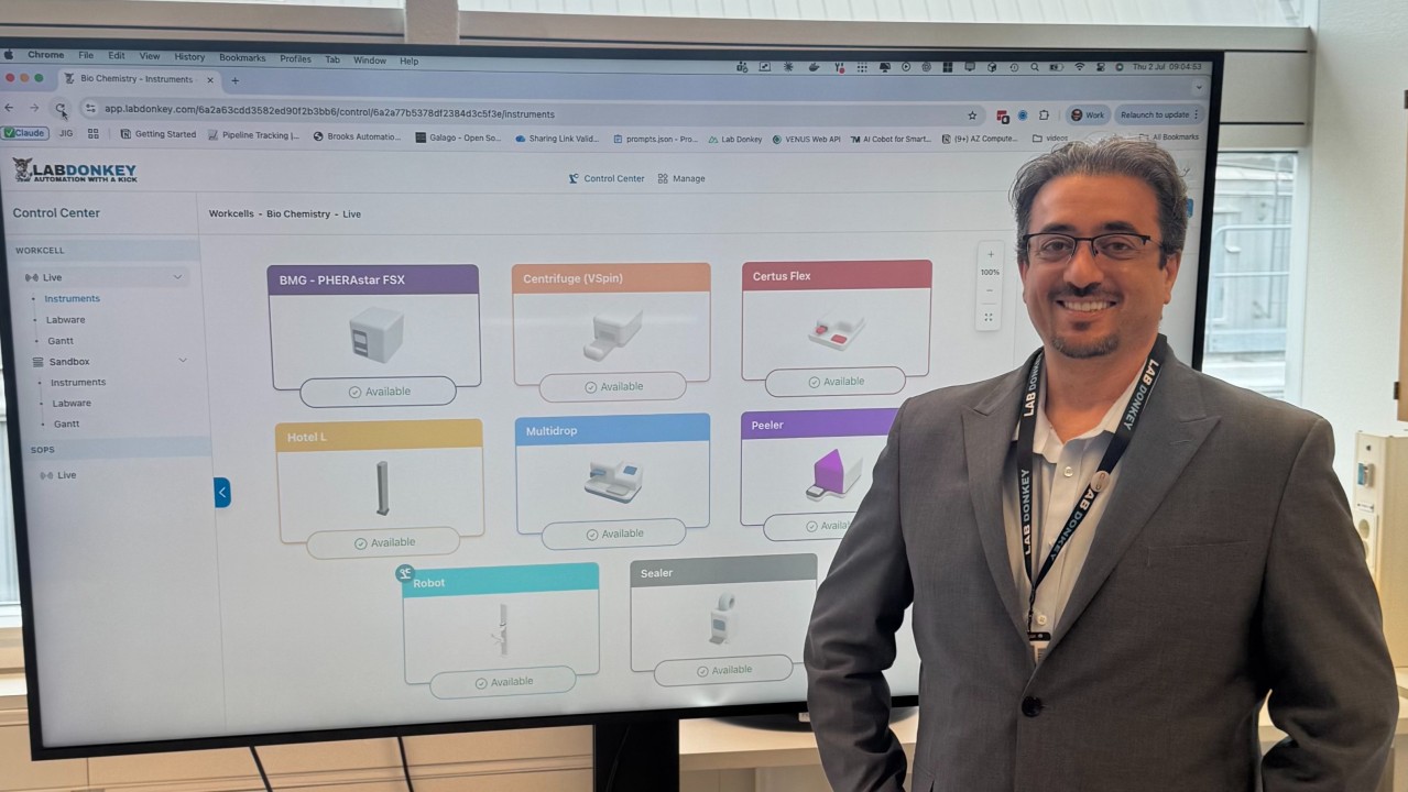 Safwan next to the Lab Donkey Control Center showing a live workcell